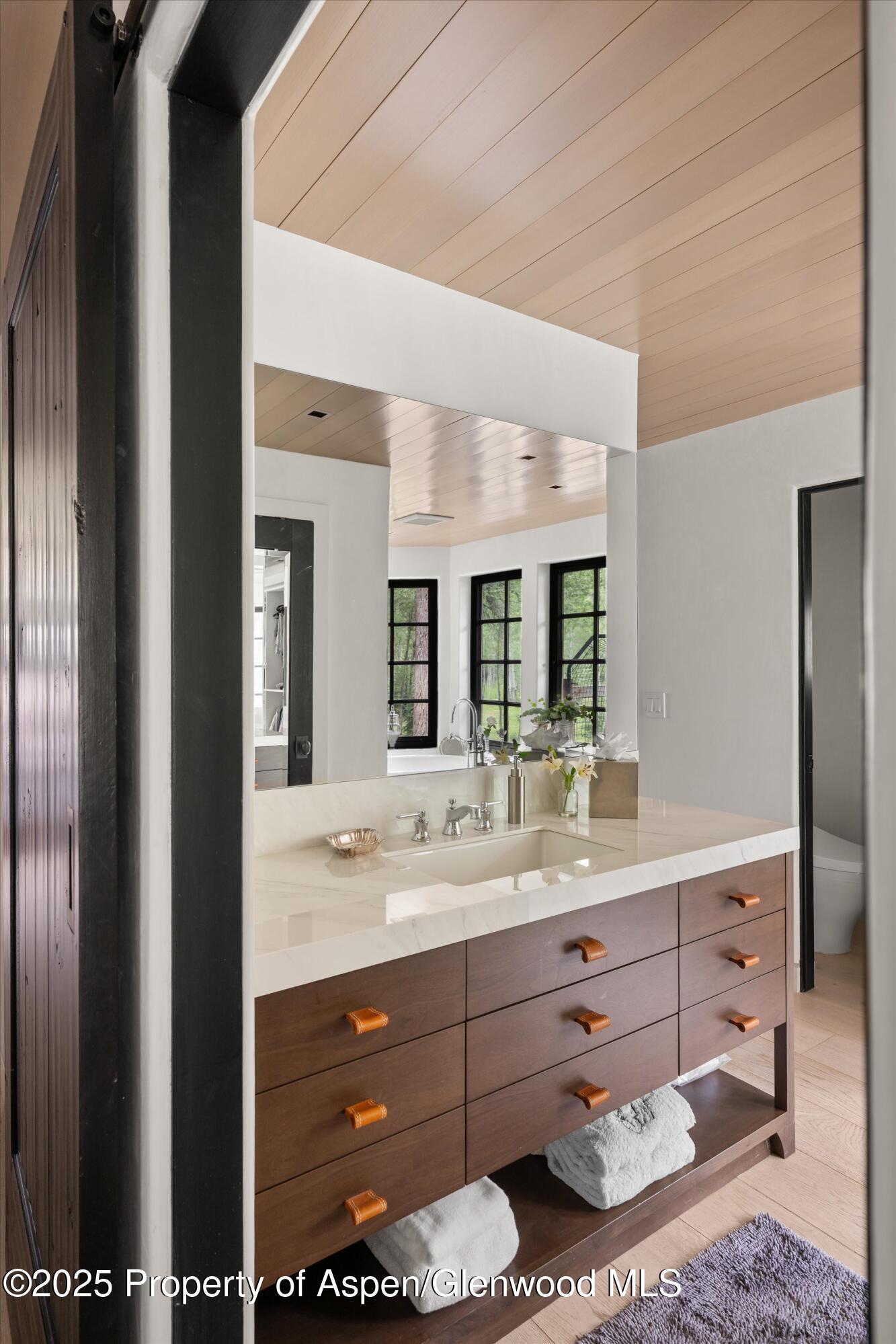 6458 Snowmass Creek Road Snowmass, CO 81654 - Photo 54 of 114 a bathroom with a double vanity sink and mirror