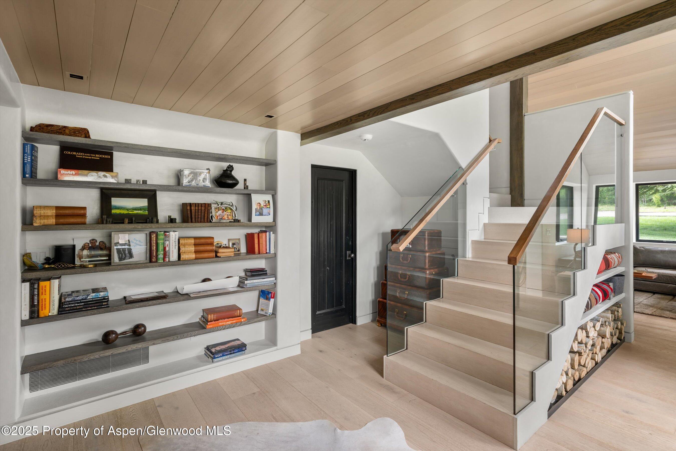 6458 Snowmass Creek Road Snowmass, CO 81654 - Photo 59 of 114 a view of staircase with lots of books and knick knacks on it