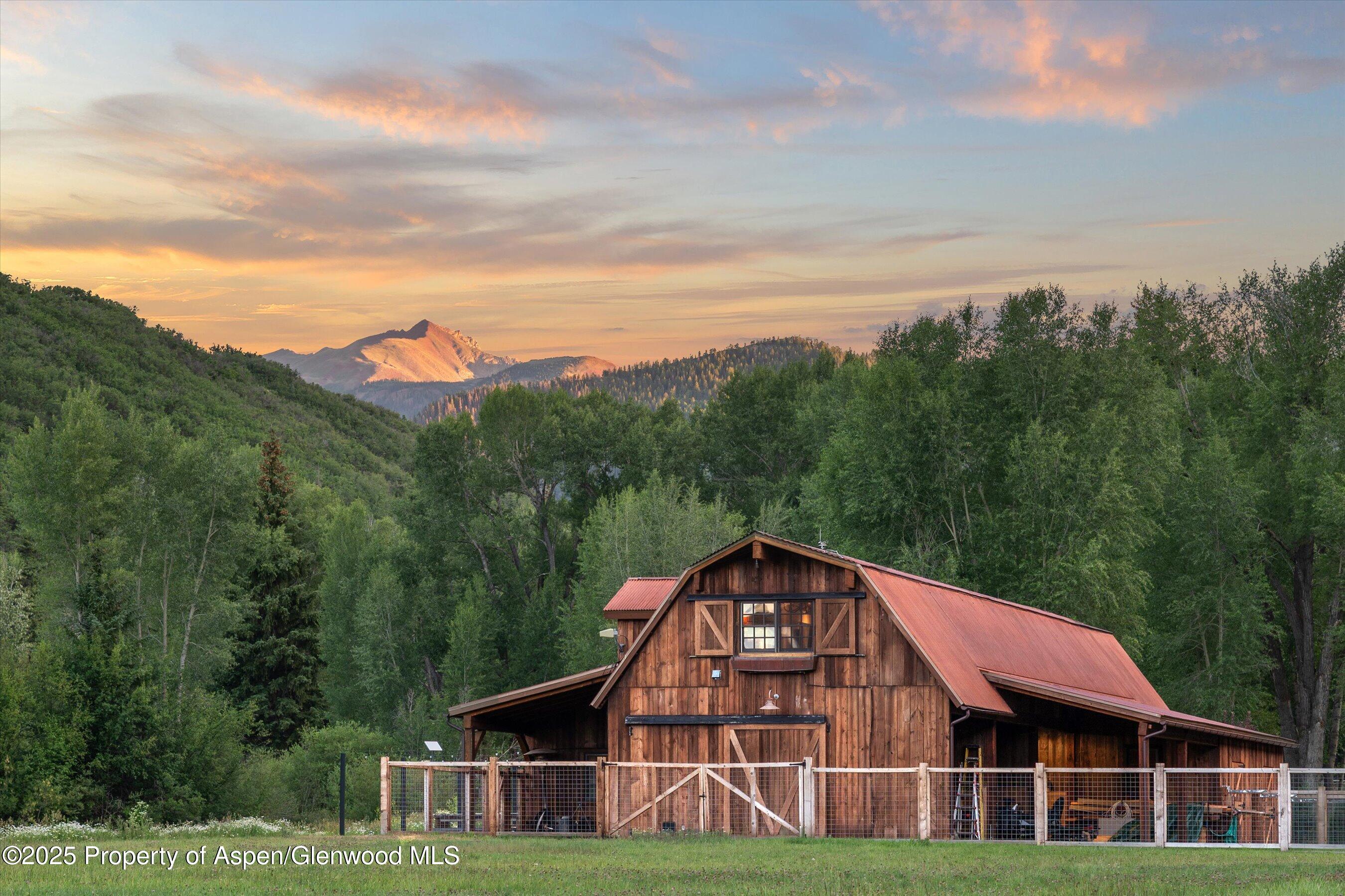 6458 Snowmass Creek Road Snowmass, CO 81654 - Photo 66 of 114 a view of a big house with a big yard and large trees