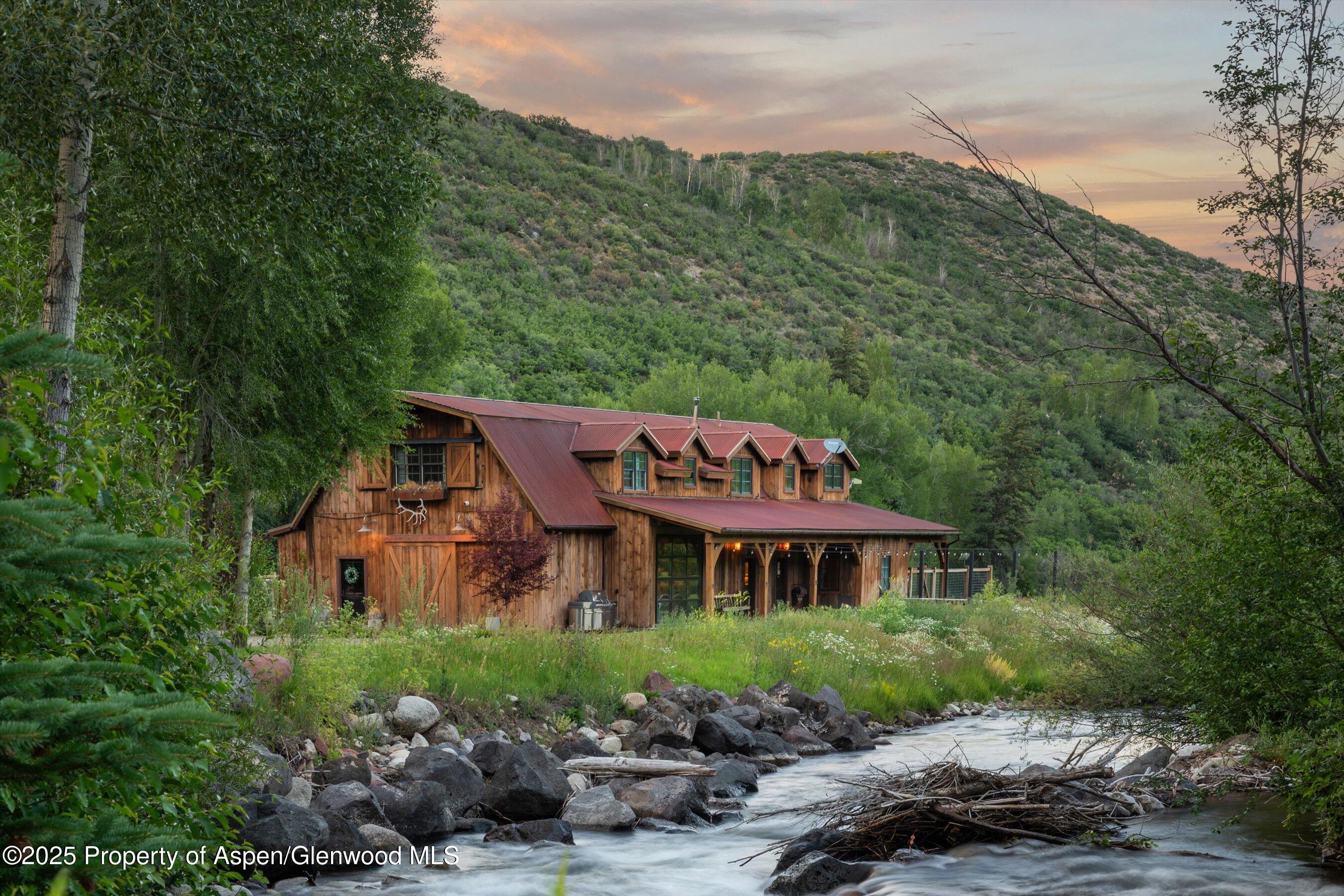 6458 Snowmass Creek Road Snowmass, CO 81654 - Photo 68 of 114 a front view of a house with a garden