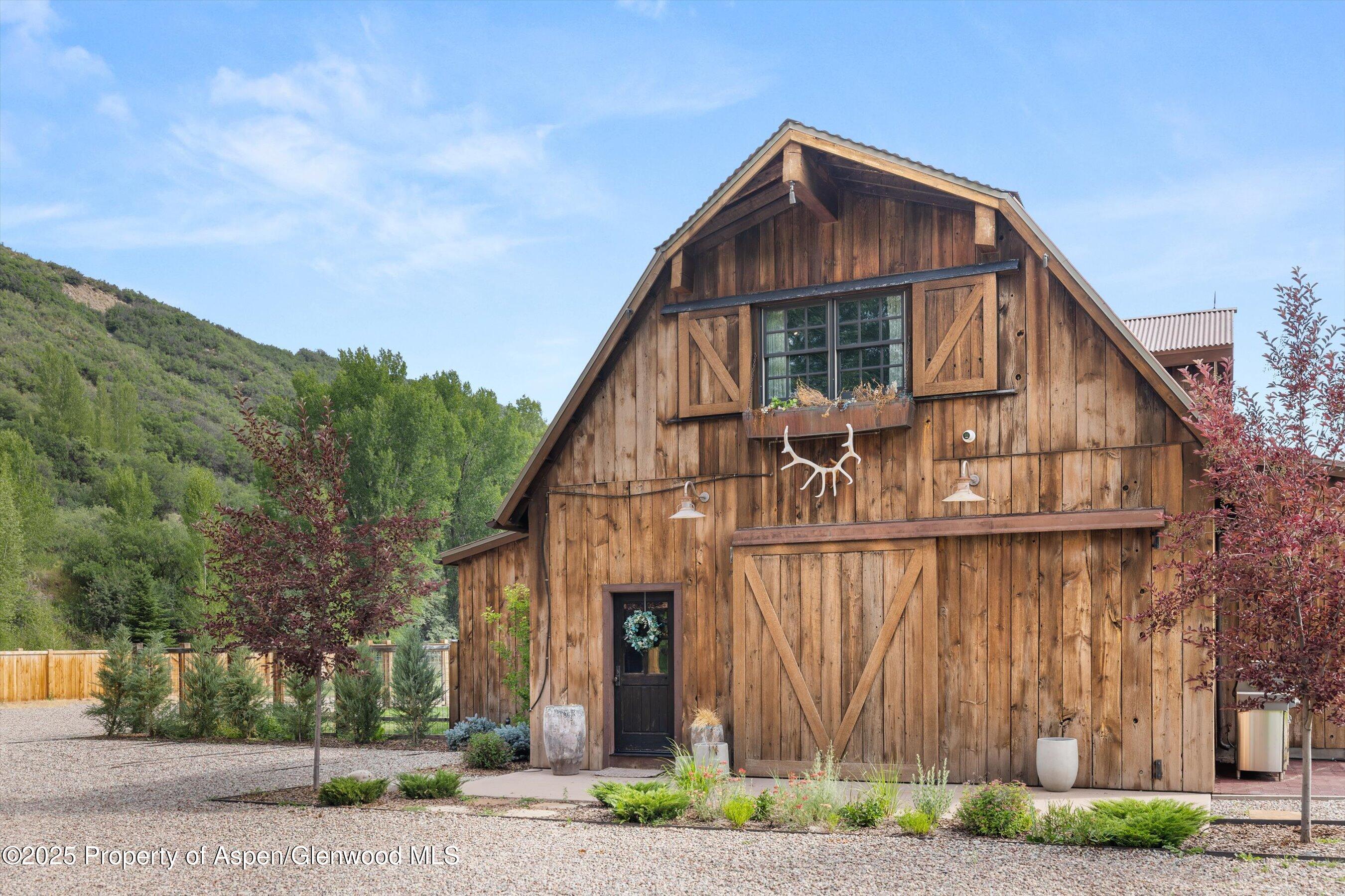 6458 Snowmass Creek Road Snowmass, CO 81654 - Photo 71 of 114 a view of a house with a yard next to a road