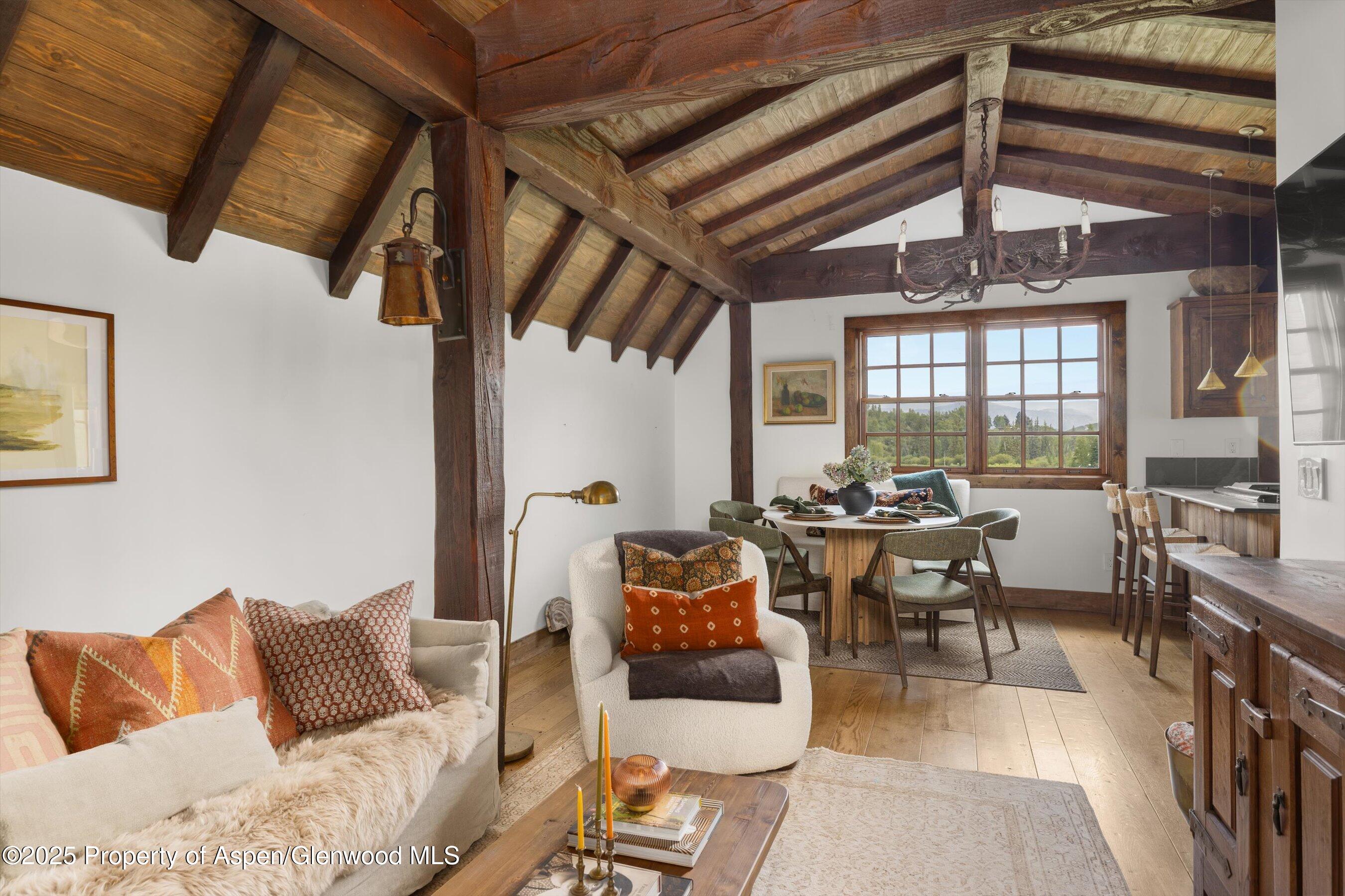 6458 Snowmass Creek Road Snowmass, CO 81654 - Photo 77 of 114 a living room with furniture and a chandelier