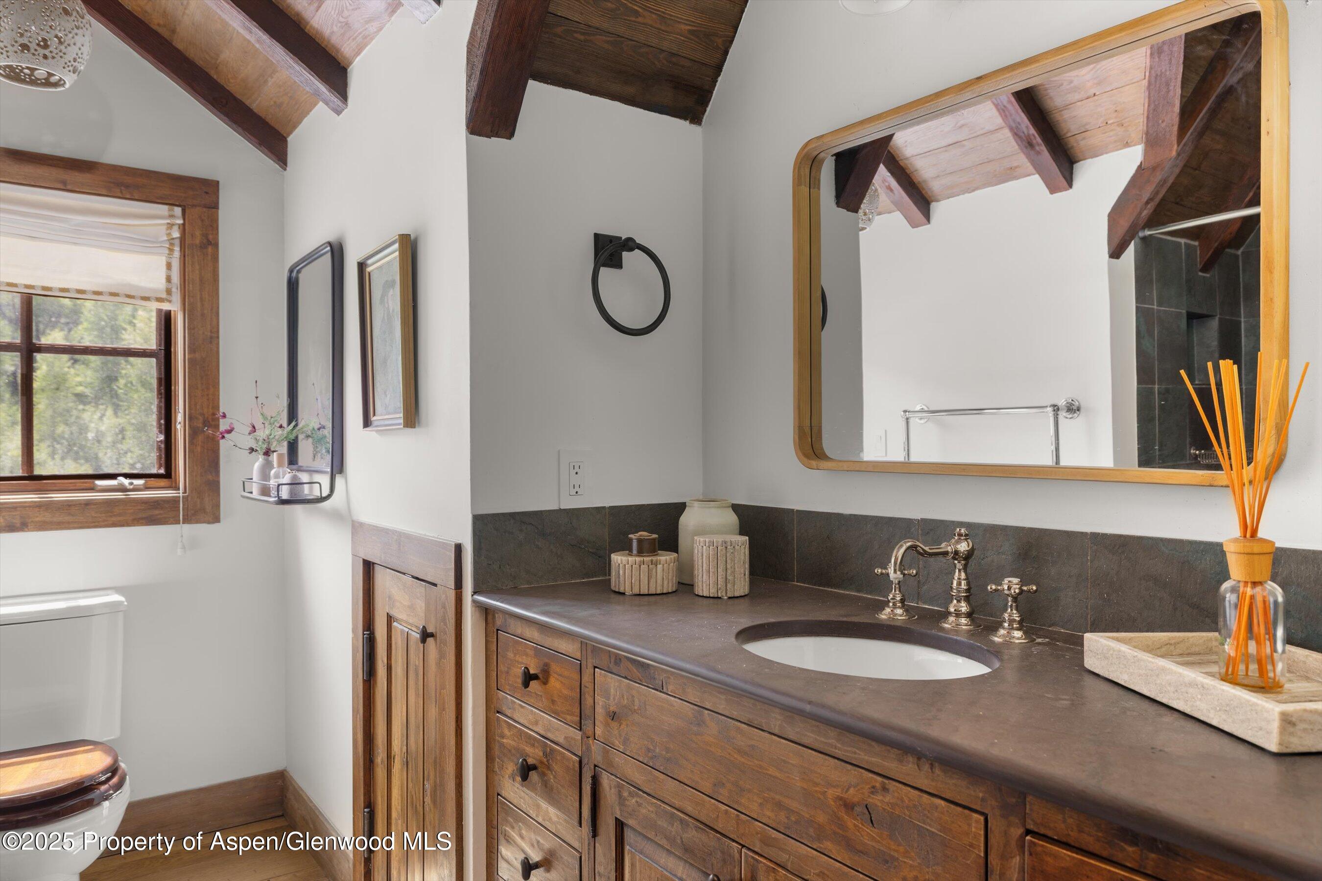 6458 Snowmass Creek Road Snowmass, CO 81654 - Photo 83 of 114 a bathroom with a granite countertop sink and a mirror