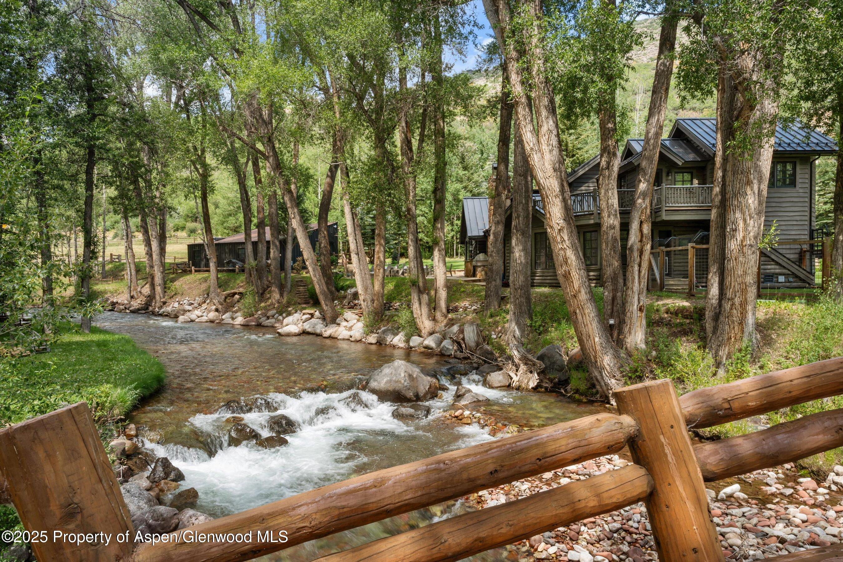 6458 Snowmass Creek Road Snowmass, CO 81654 - Photo 9 of 114 a view of a backyard with wooden fence