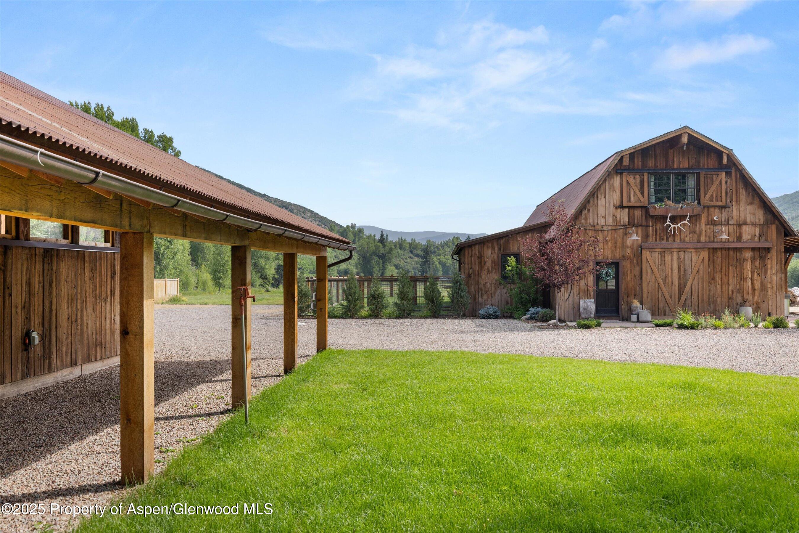 6458 Snowmass Creek Road Snowmass, CO 81654 - Photo 91 of 114 a view of an house with backyard and a tree
