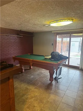 a living room with a table and a fireplace