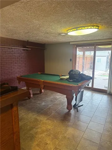 a living room with a table and a fireplace