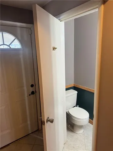 a white toilet sitting next to a bathroom sink