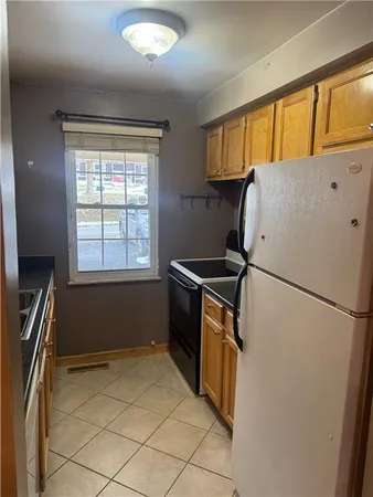 a refrigerator freezer sitting inside of a kitchen