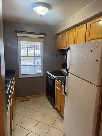 a refrigerator freezer sitting inside of a kitchen