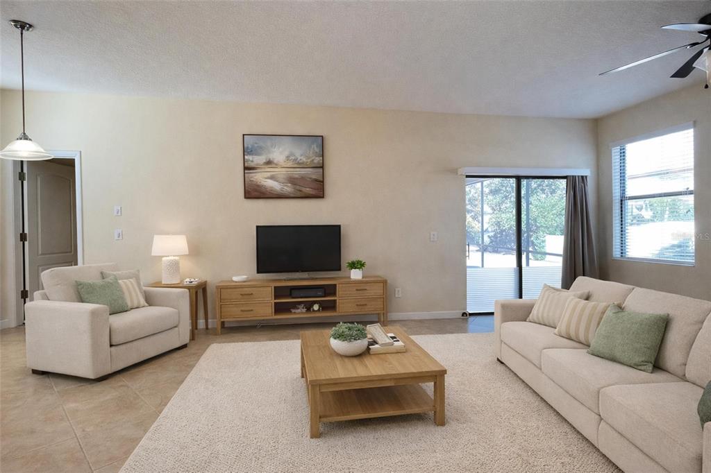 15401 Porter Road Winter Garden, FL 34787 - Photo 14 of 59 a living room with furniture a flat screen tv and a window