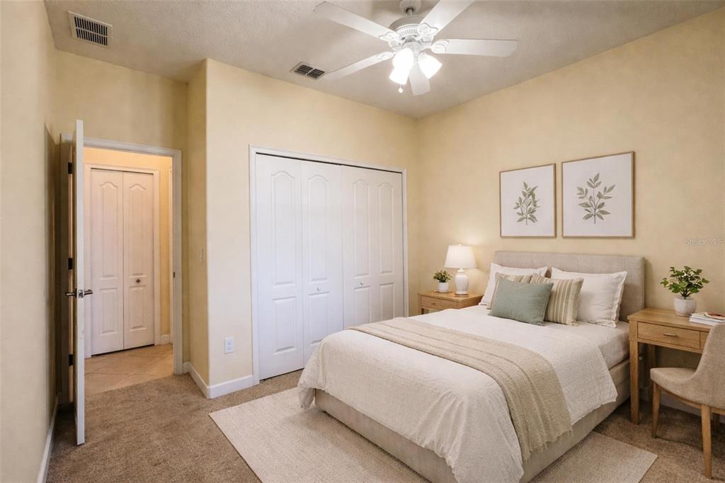 15401 Porter Road Winter Garden, FL 34787 - Photo 16 of 59 a bedroom with a large bed and a chandelier