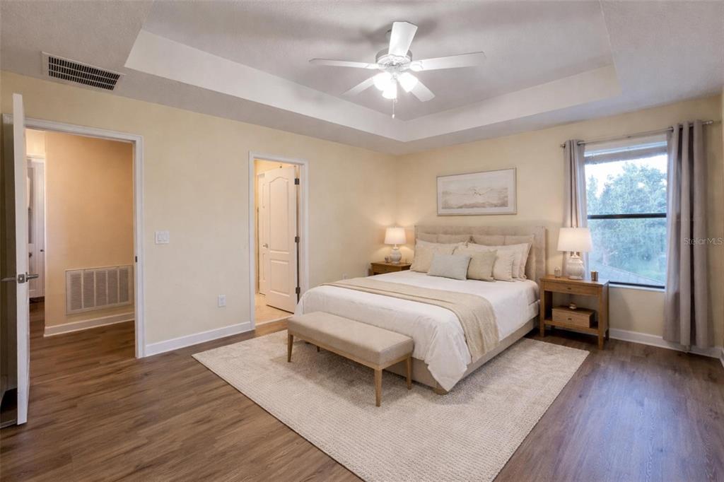 15401 Porter Road Winter Garden, FL 34787 - Photo 17 of 59 a bedroom with a large bed chandelier and a window