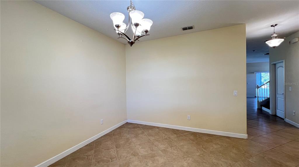 15401 Porter Road Winter Garden, FL 34787 - Photo 19 of 59 wooden floor in an empty room with a chandelier