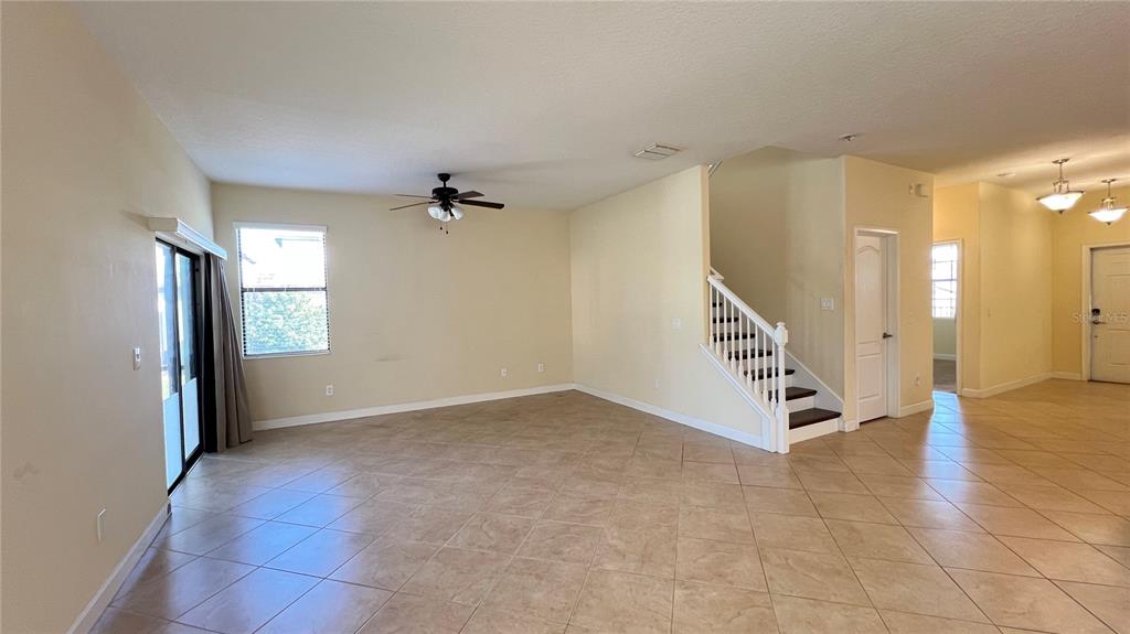 15401 Porter Road Winter Garden, FL 34787 - Photo 36 of 59 a view of an empty room with stairs and a ceiling fan