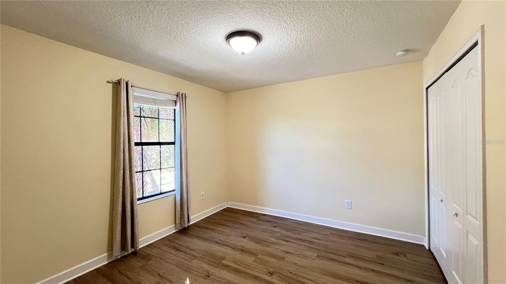 15401 Porter Road Winter Garden, FL 34787 - Photo 49 of 59 an empty room with wooden floor and windows