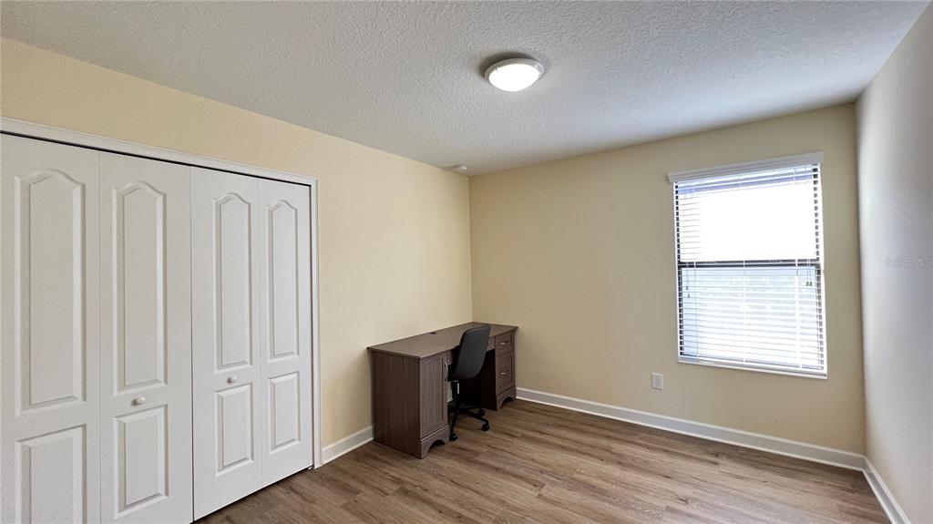 15401 Porter Road Winter Garden, FL 34787 - Photo 51 of 59 an empty room with wooden floor and windows