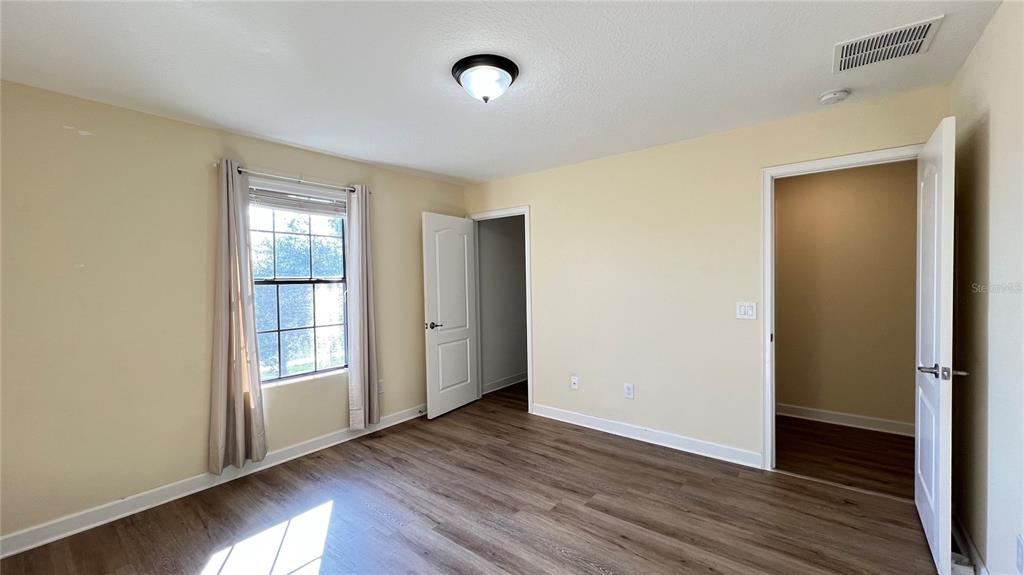 15401 Porter Road Winter Garden, FL 34787 - Photo 52 of 59 an empty room with wooden floor and windows