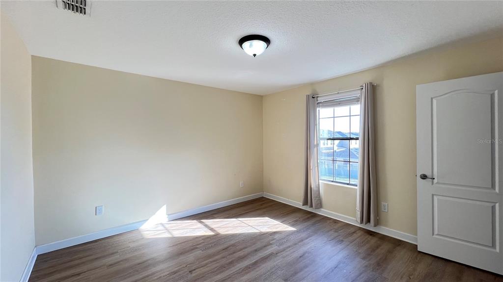 15401 Porter Road Winter Garden, FL 34787 - Photo 53 of 59 an empty room with wooden floor and windows