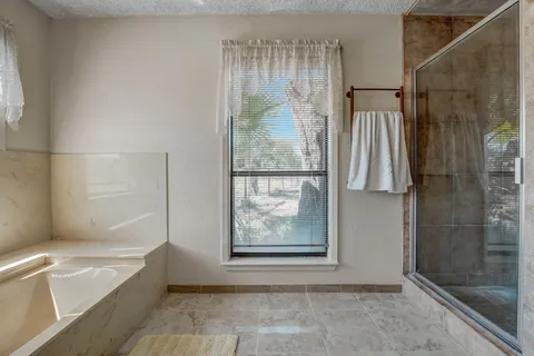 a bathroom with a bathtub and shower