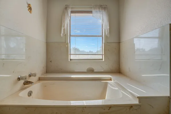 a white bath tub sitting next to a window