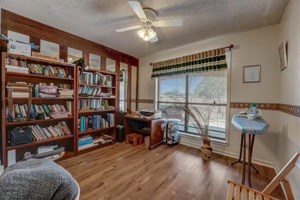 a view of a livingroom with furniture and a book shelf