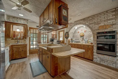 a kitchen with stainless steel appliances granite countertop a stove and a sink