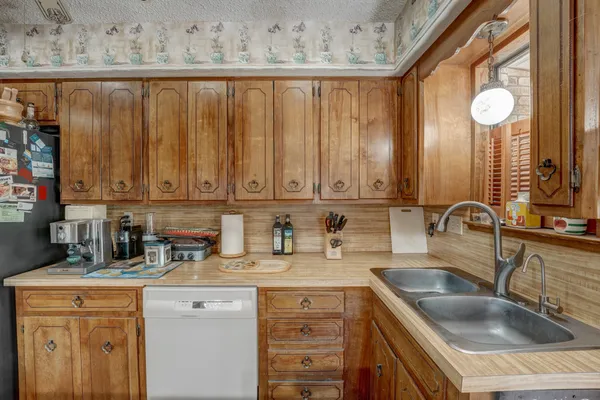 a kitchen with a sink cabinets and window