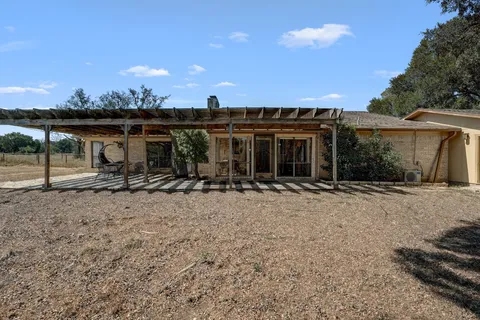 a front view of house with yard and trees