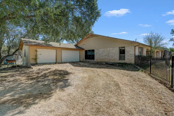 a front view of house with yard and trees