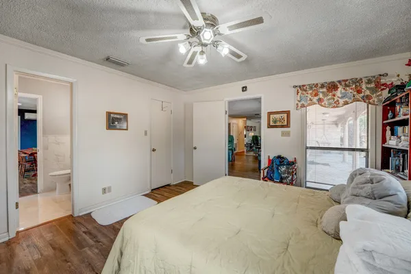 a bedroom with a large bed and a chandelier