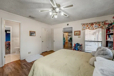 a bedroom with a large bed and a chandelier