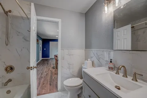 a bathroom with a sink toilet and shower