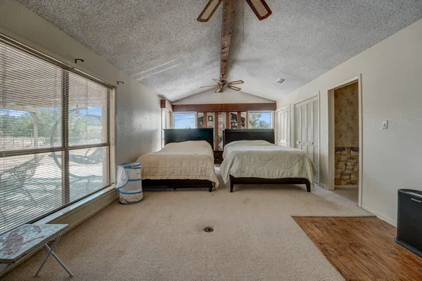 a bedroom with furniture and large window