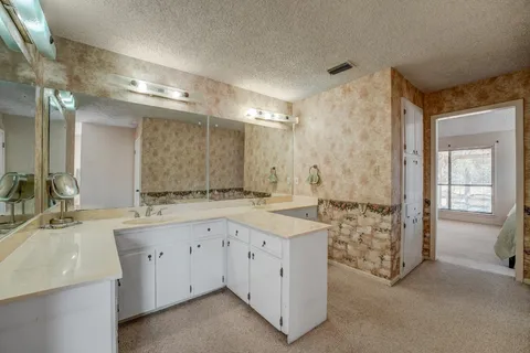 a bathroom with double sink and a mirror