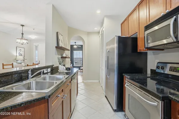 a kitchen with a sink stove and refrigerator