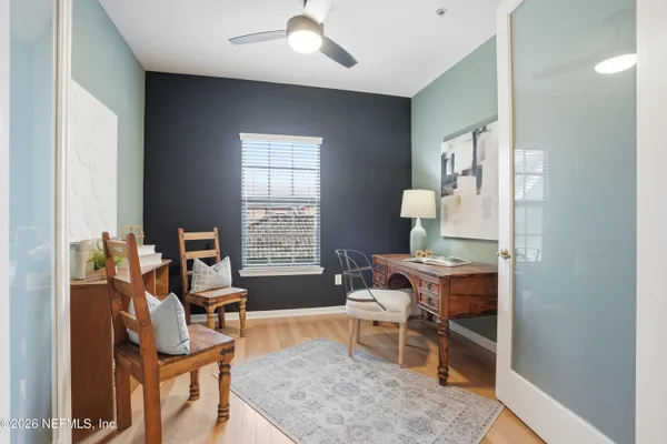 a living room with furniture a rug and a window