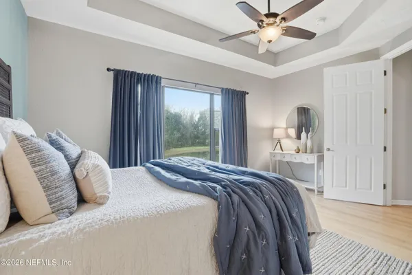 a bedroom with a large bed and a chandelier