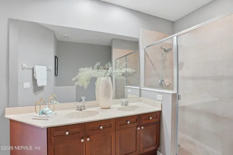 a bathroom with a sink double vanity and a mirror