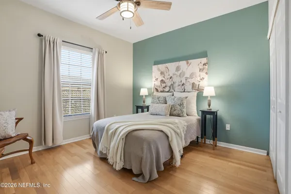a spacious bedroom with a bed and a window