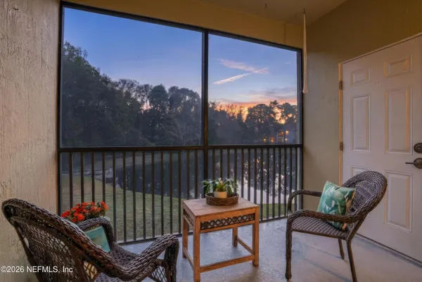 a view of a balcony with furniture