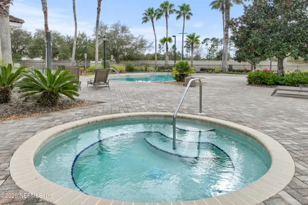 a view of a swimming pool with outdoor seating