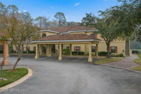 a view of a house with a patio and a yard