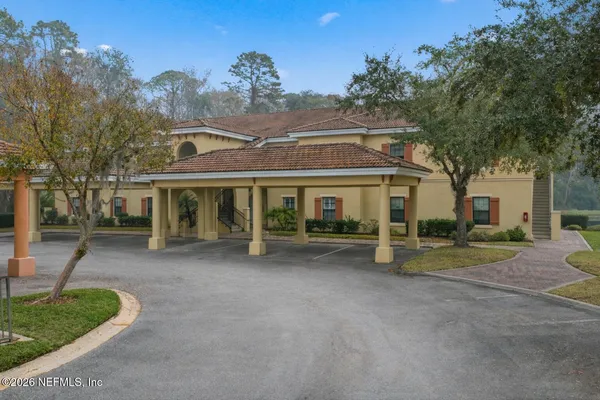 a view of a house with a patio and a yard