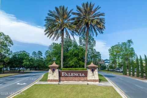 a view of a swimming pool with a garden and trees