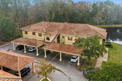 an aerial view of a house with a yard and balcony