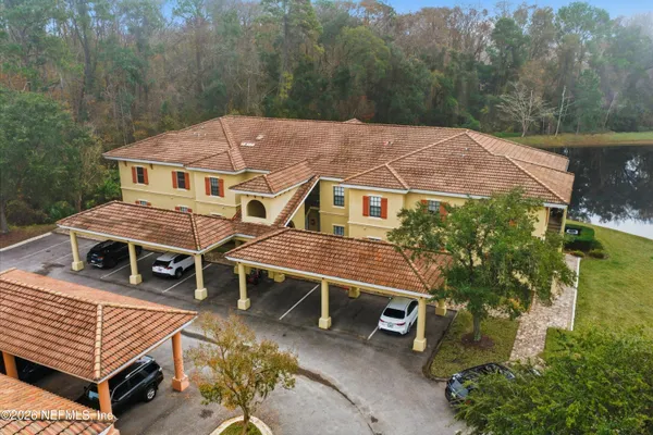 an aerial view of a house with a yard and balcony