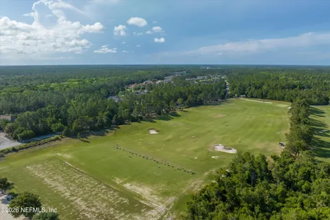 a view of a big yard with lots of green space