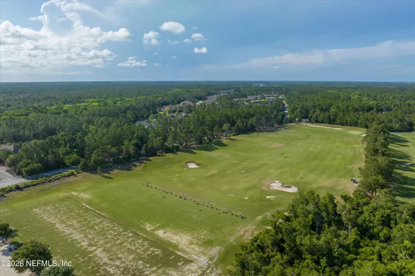 a view of a big yard with lots of green space