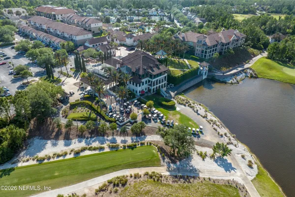 an aerial view of a house with a garden and lake view